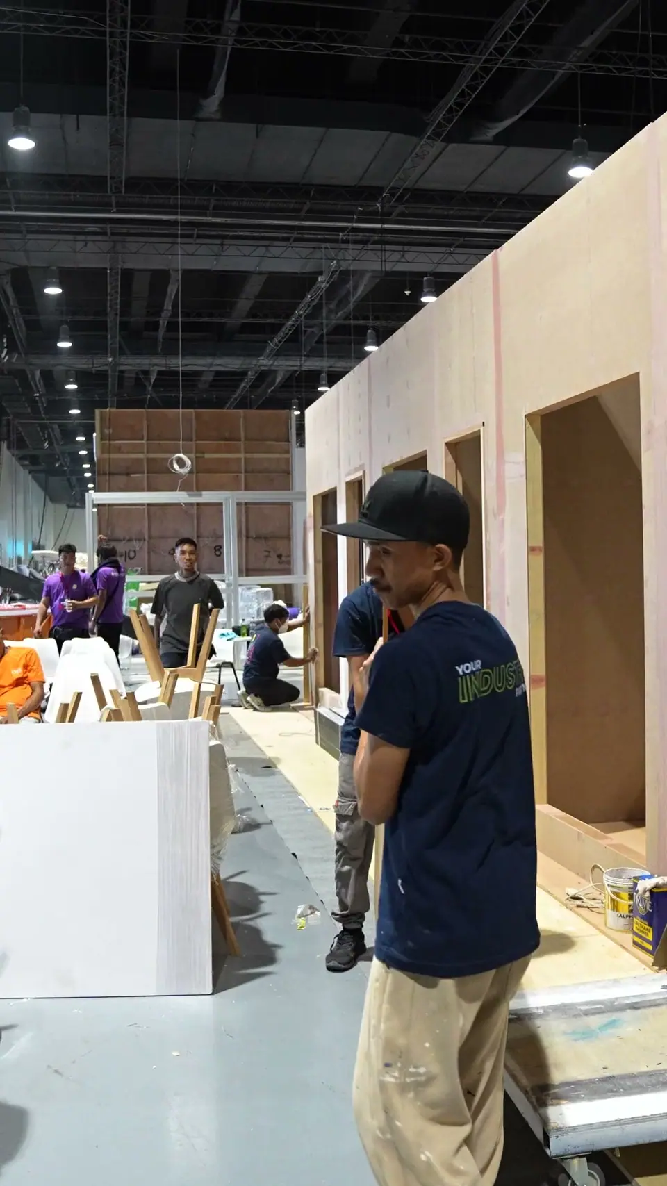 Sign Depot carpenters building exhibition booth walls on the show floor